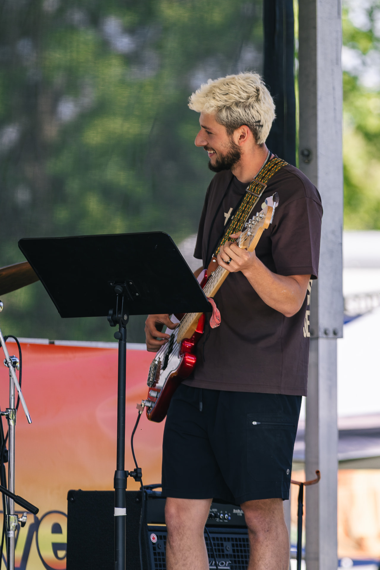 A guitarist leading worship on an outdoor stage