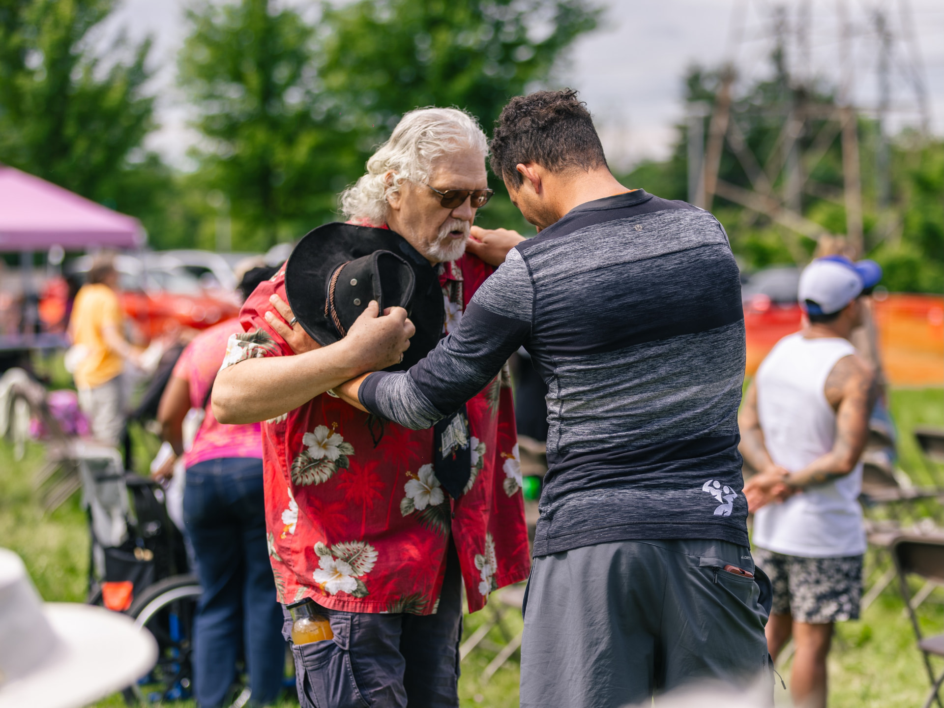 Two men praying together at an outdoor Souled Out gathering